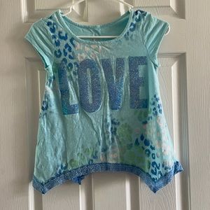 Cute sharkbite glittered Justice graphic tee.